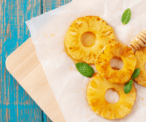 grilled pineapple rings on cutting board