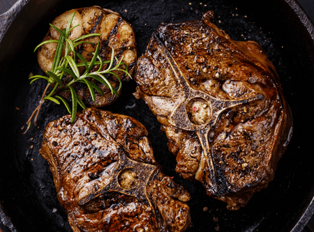 lamb loin chops in skillet with garlic and rosemary