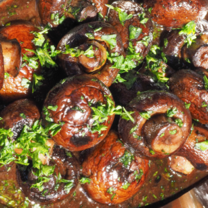 burgundy mushrooms with fresh herbs as garnish