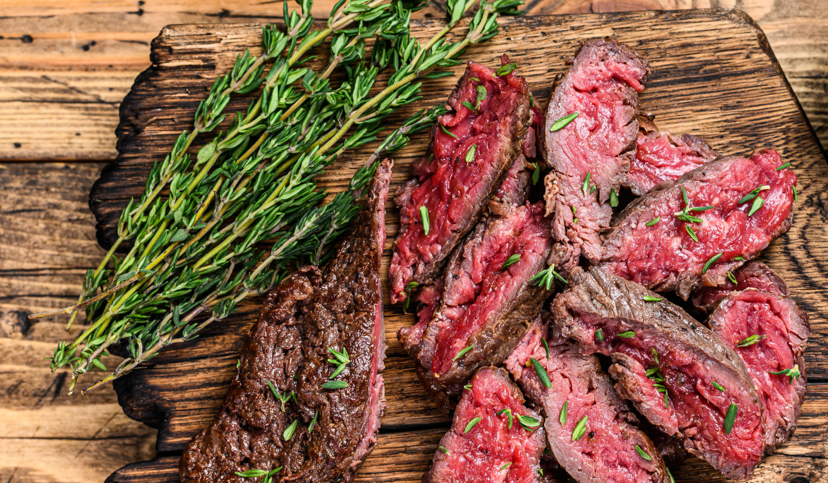 medium rare churrasco steak sliced thin and garnished with rosemary