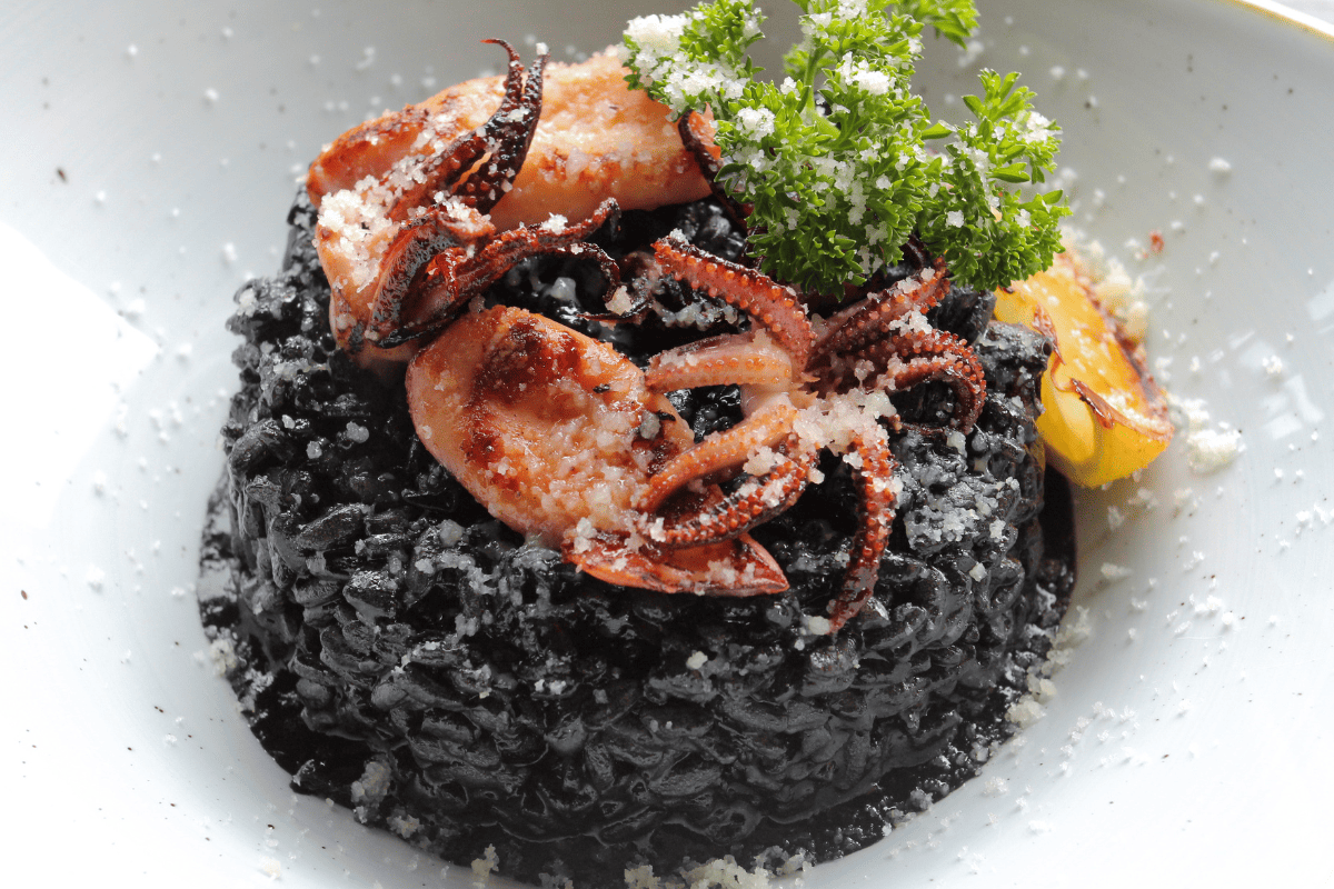 forbidden black rice topped with calamari and shrimp